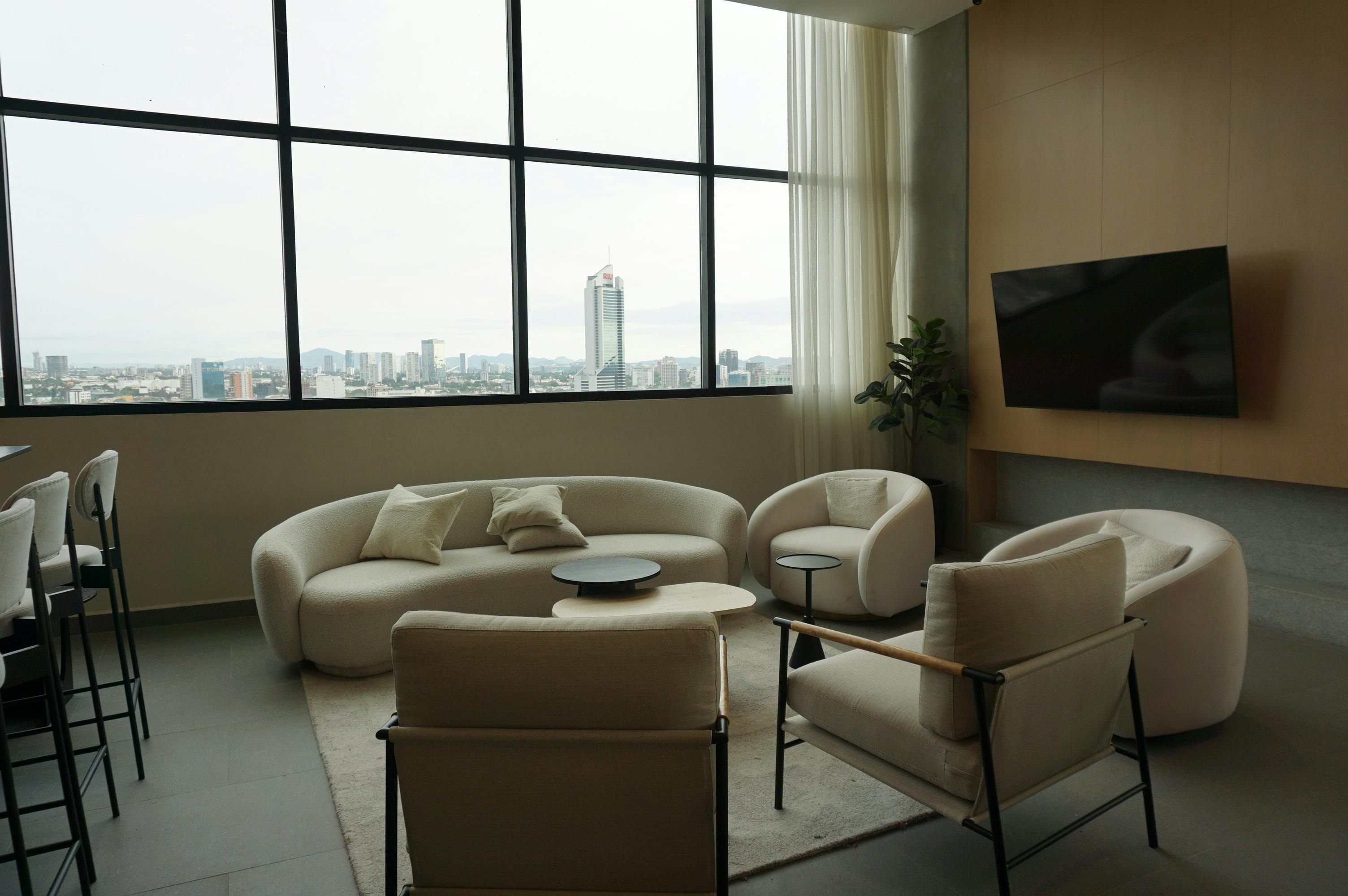 Modern living room with large windows and a city view