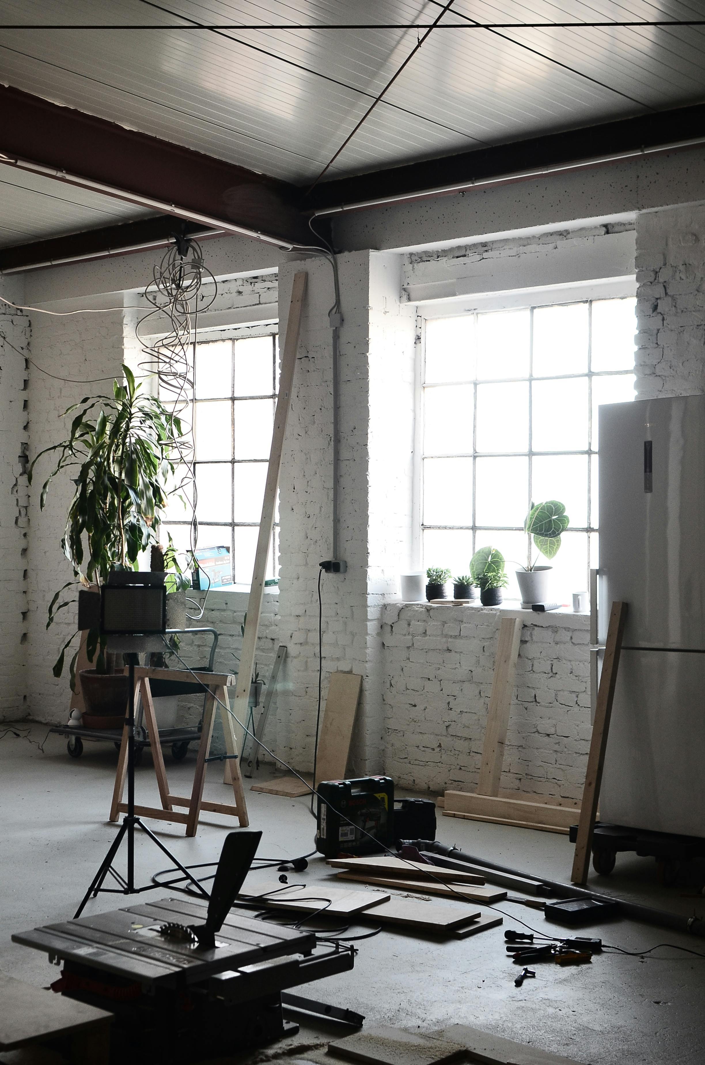 Fresh interior during rental preparation with painting supplies and ladder